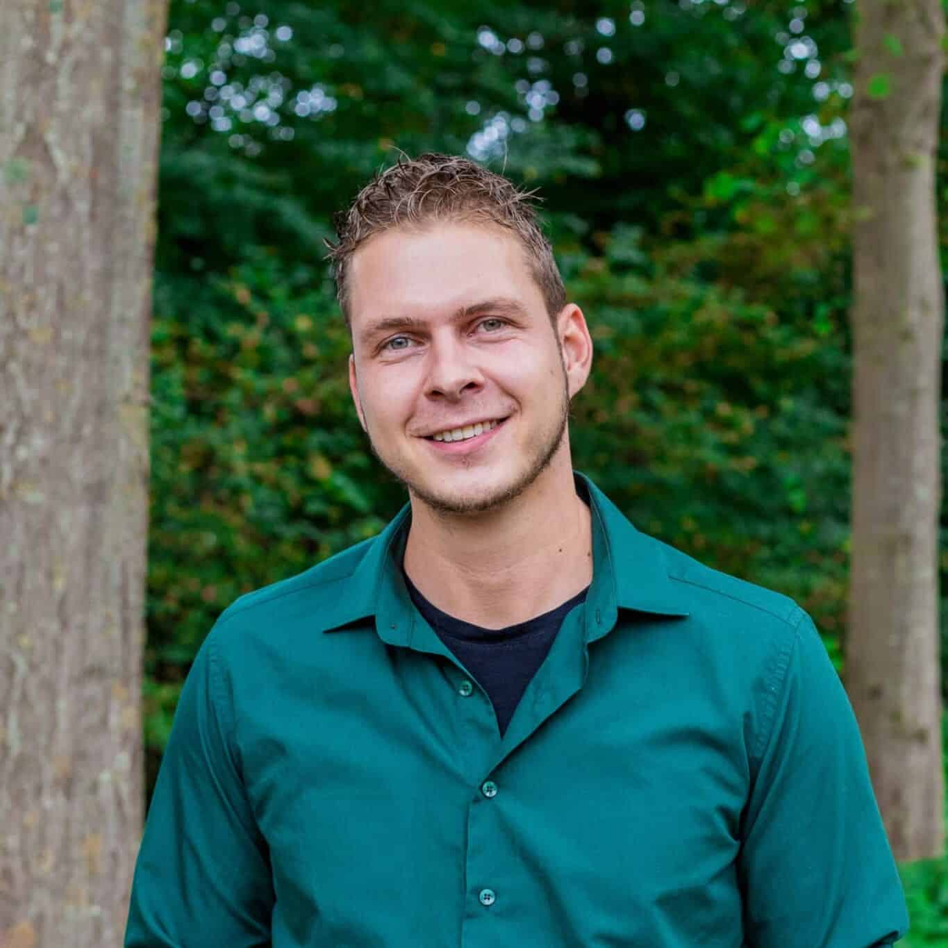 Stan online marketeer bij Positie1 lachend portret in groene buitenomgeving